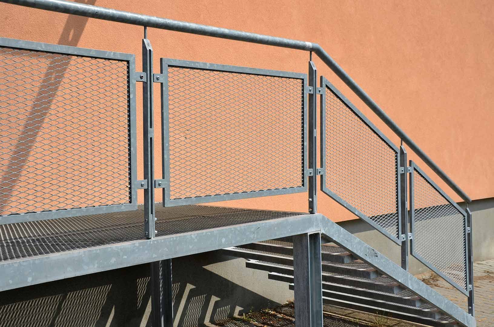 A Set of Stairs with A Metal Railing Leading up To a Building — FBM Fabrication In Dapto, NSW