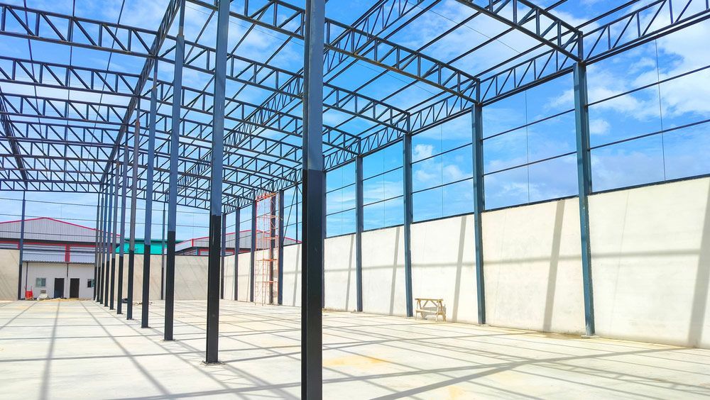 An Empty Warehouse Under Construction with A Blue Sky in The Background — FBM Fabrication In Shellharbour, NSW