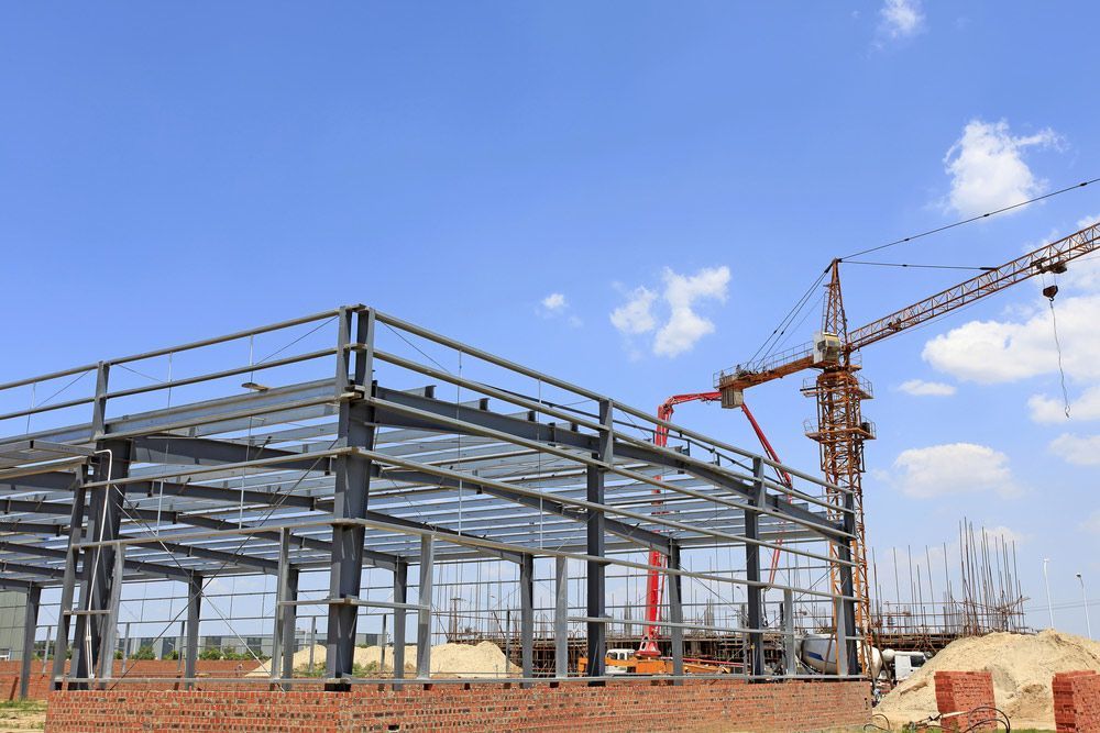 A Building Is Being Built with A Crane in The Background — FBM Fabrication In Nowra, NSW