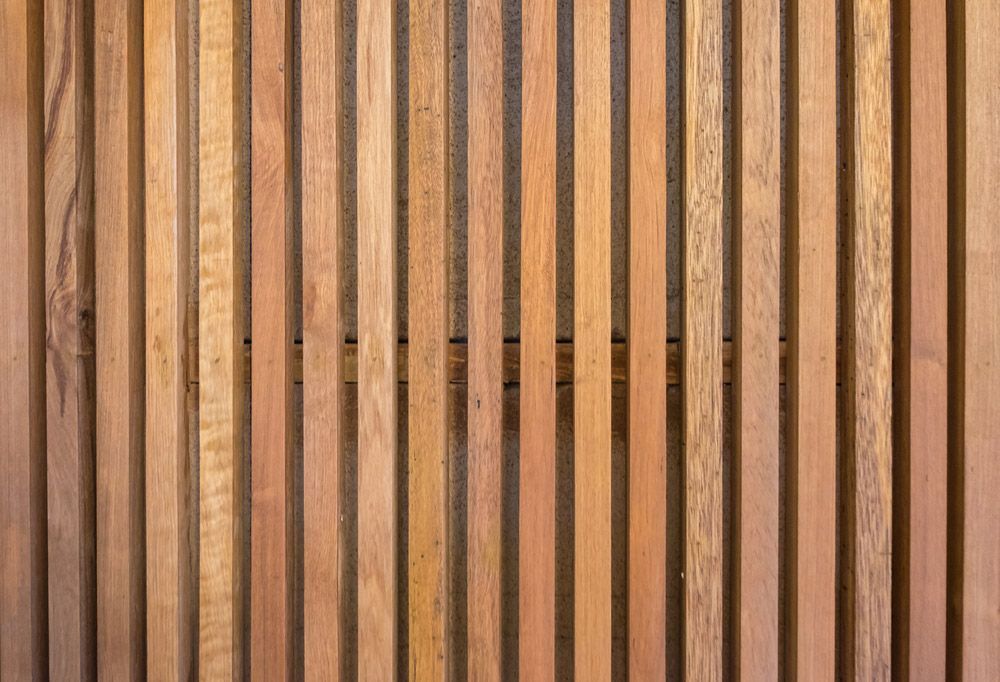 A Close up Of a Wooden Fence Made of Wooden Slats — FBM Fabrication In Shellharbour, NSW
