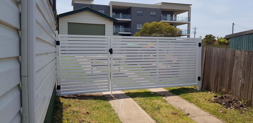 A Large House with A Wooden Fence and A Sliding Gate — FBM Fabrication In Dapto, NSW