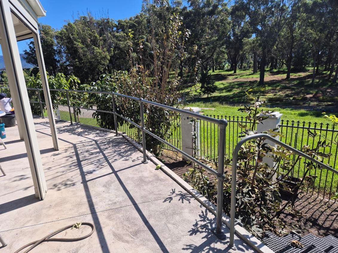Patio With Metal Railing Overlooking a Sunny Green Lawn — FBM Fabrication In Dapto, NSW