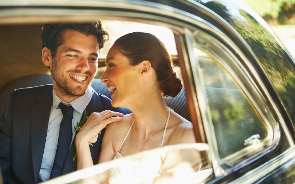 Bride and Groom are Sitting in the Back Seat of a Car — Sandy Springs, GA — Pick Your Leisure