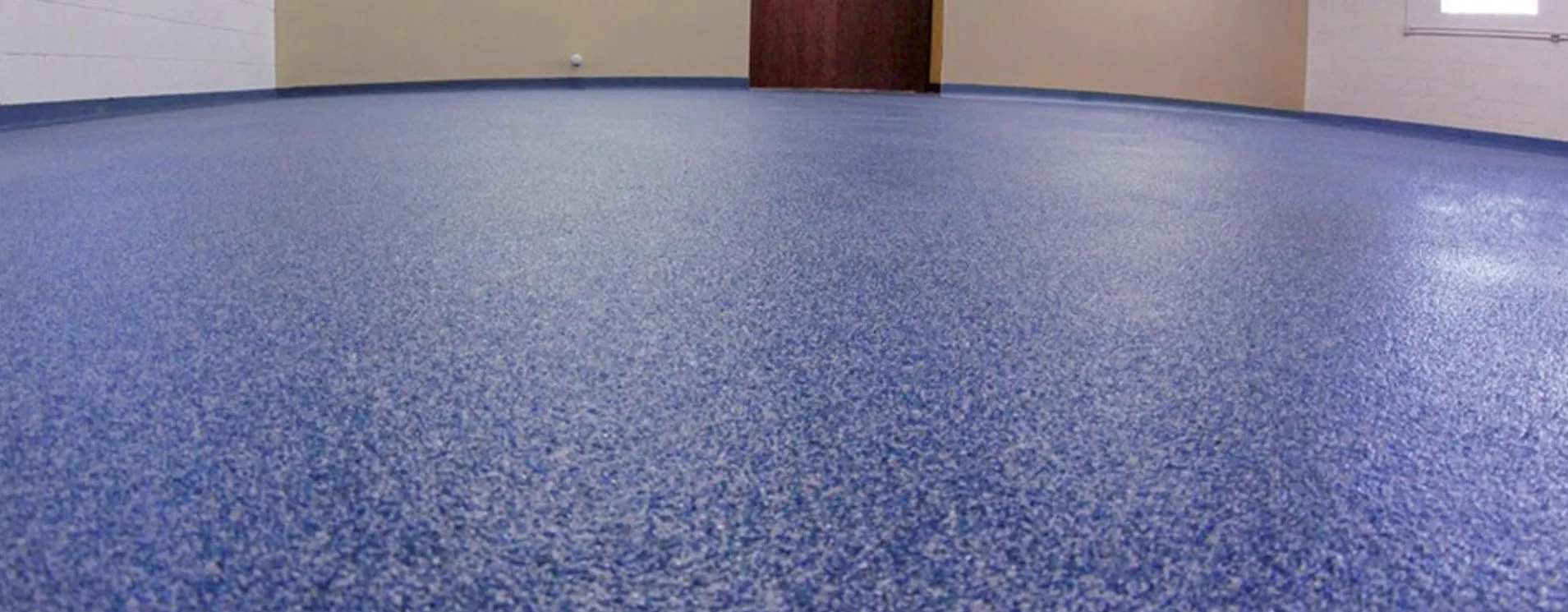 Blue speckled epoxy floor in a room.