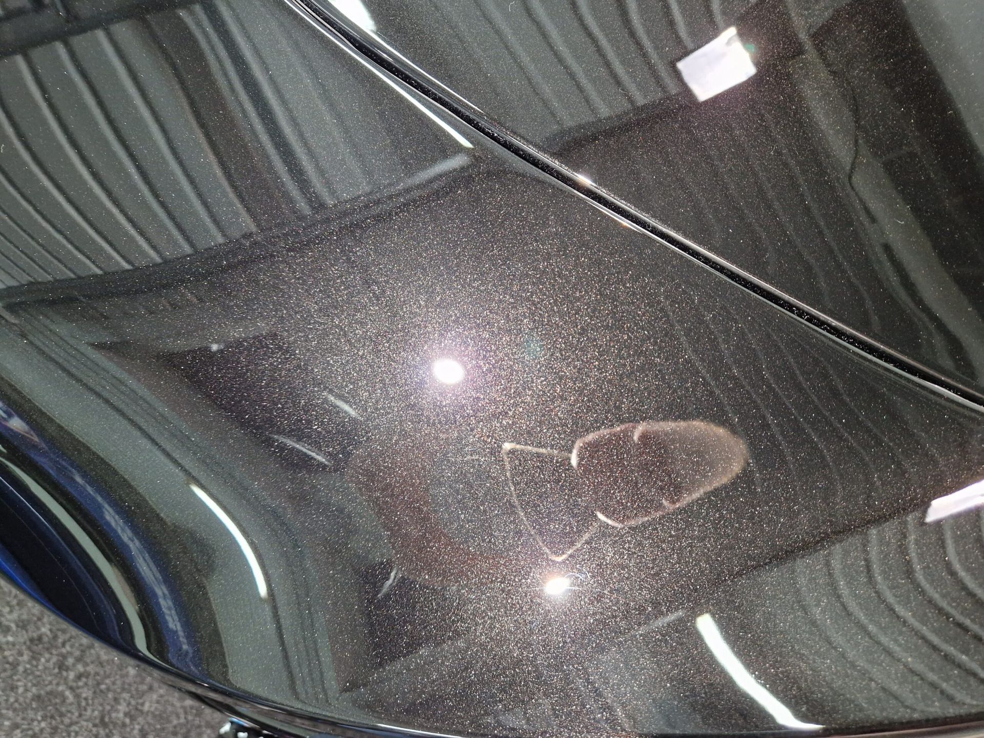 A close up of the hood of a black car.