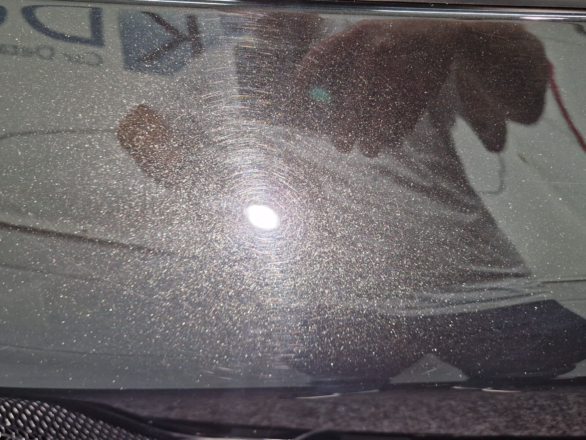 A reflection of a person in a mirror with the letter d on it