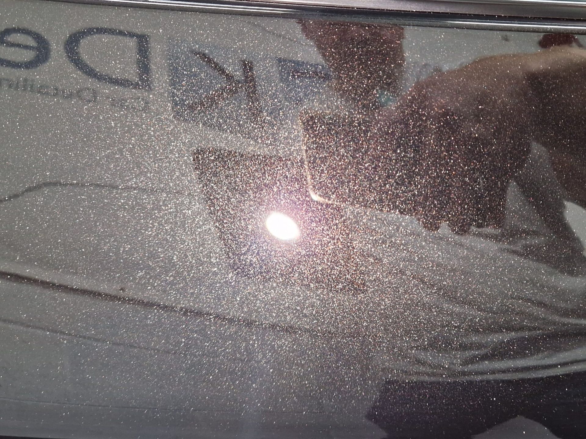 A reflection of a person in a mirror with the word de on it