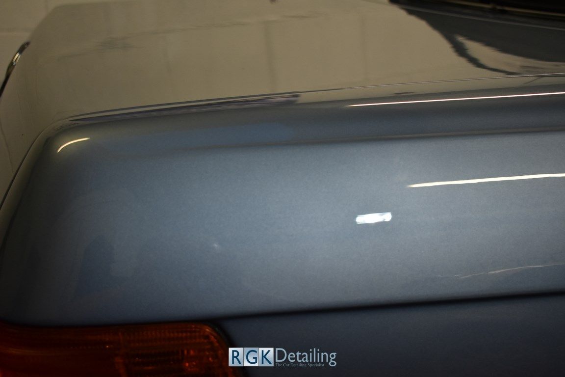 A close up of the trunk of a car with rgk detailing written on it