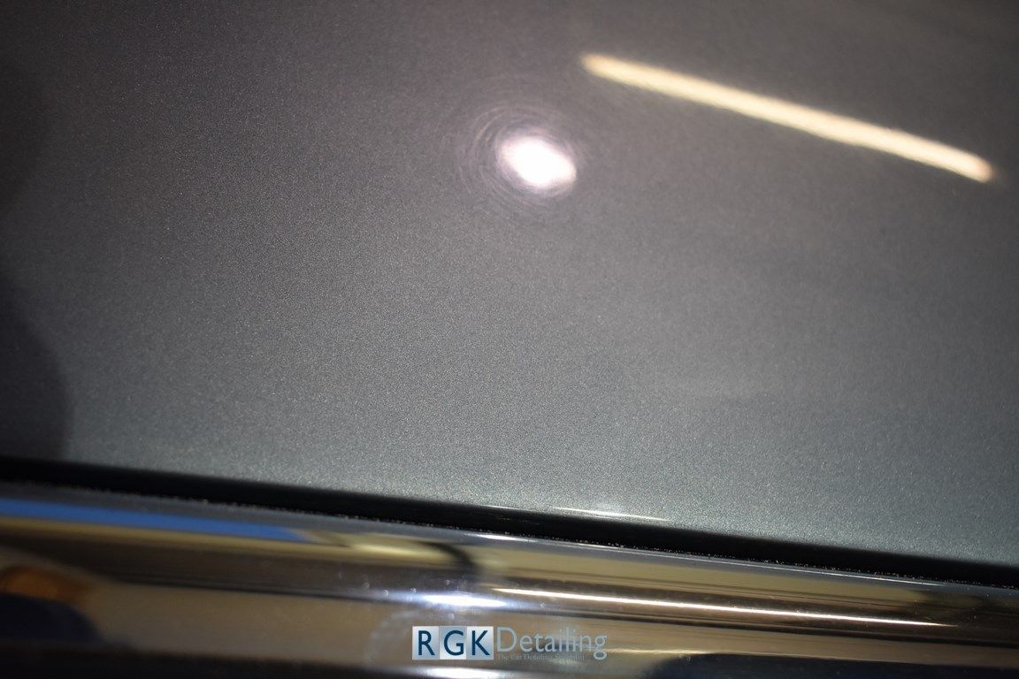 A close up of the hood of a car with rgk detailing written on it