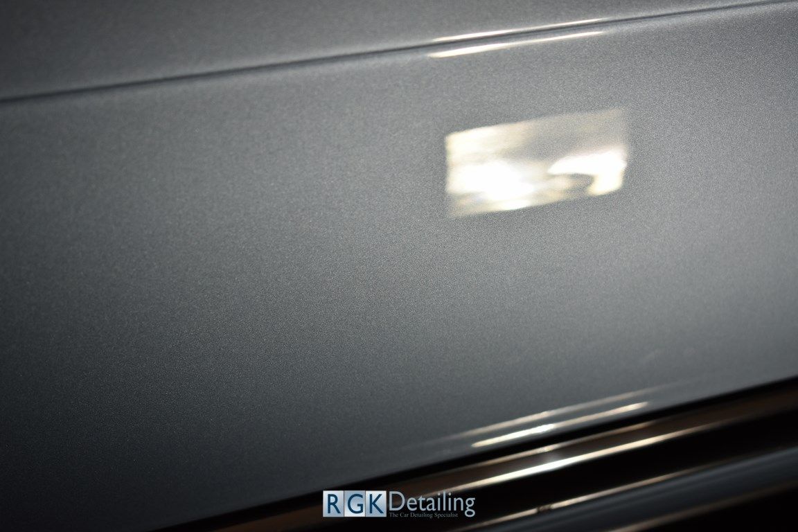A close up of a car door with rgk detailing written on it