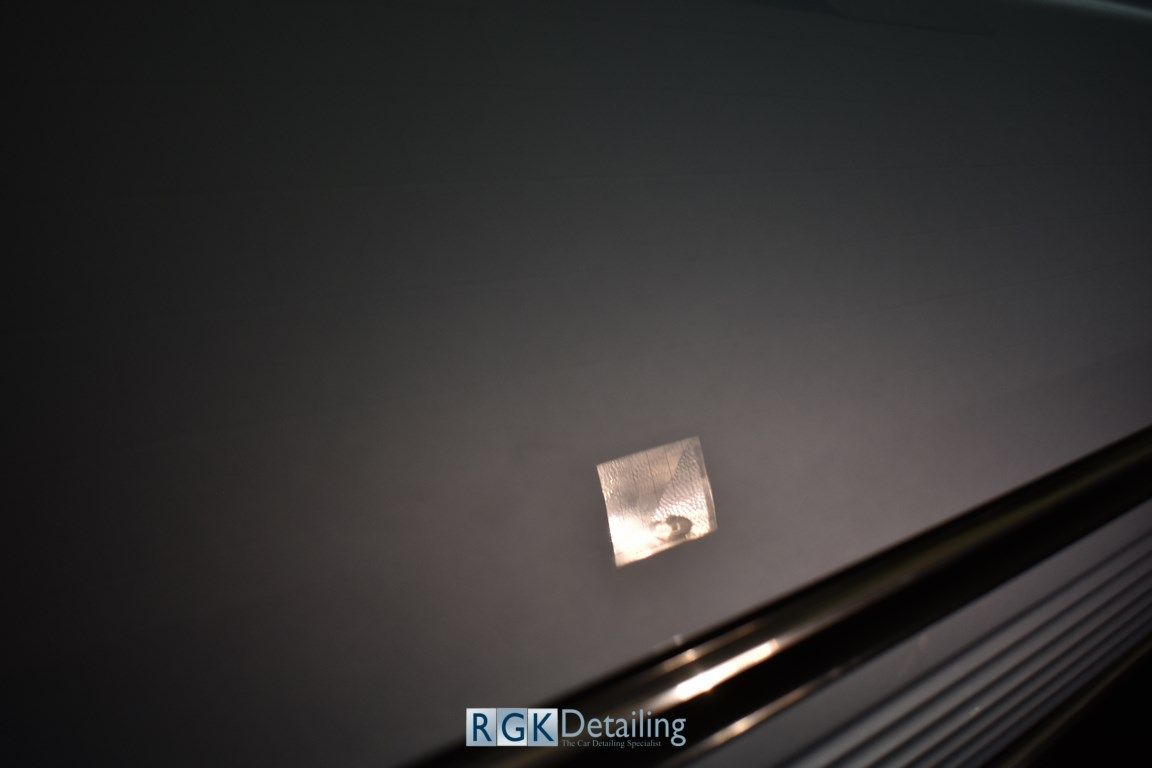 A close up of a car door with rgk detailing written on the bottom