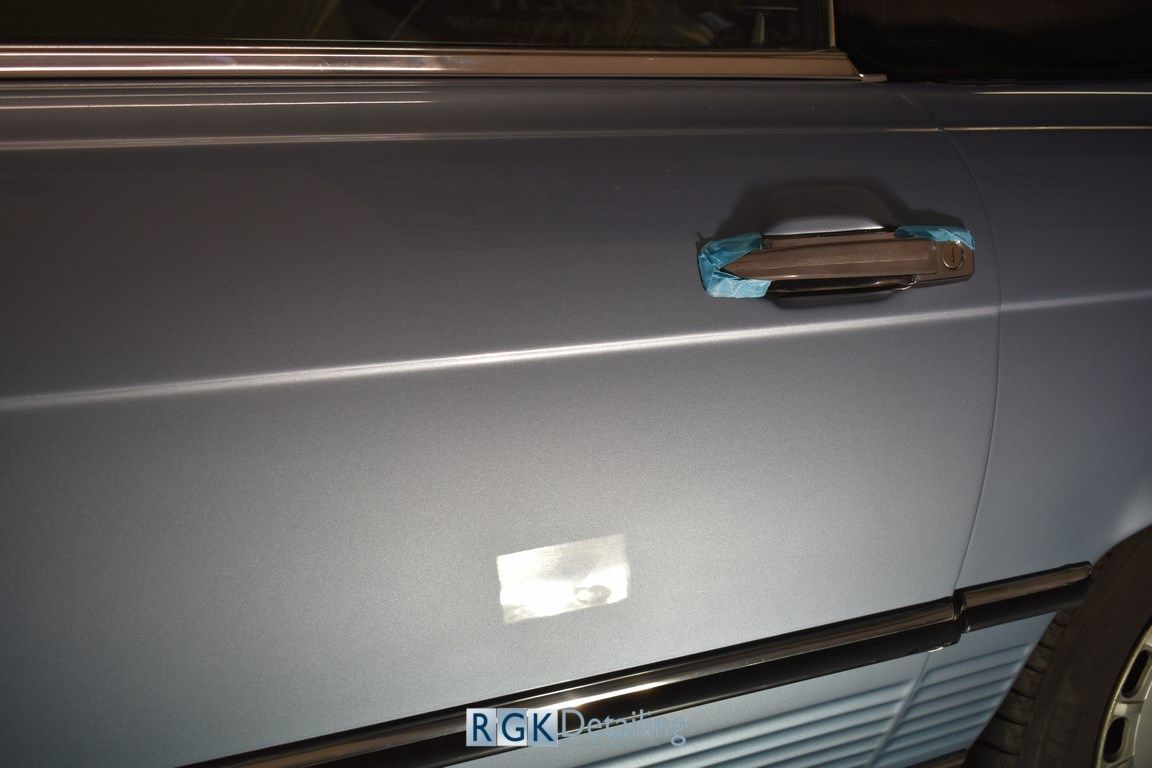 A close up of a car door with a sticker on it that says rgk