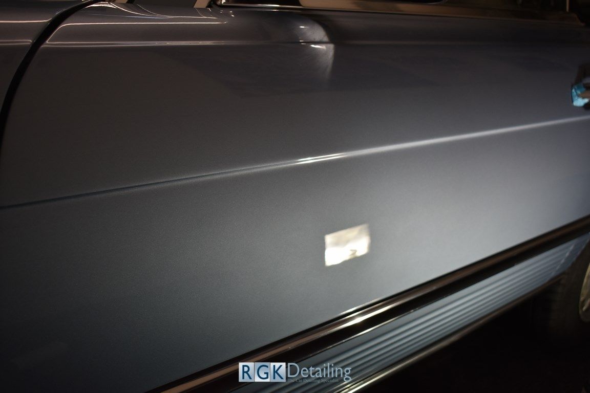 A close up of a car door with the words rgk detailing on it