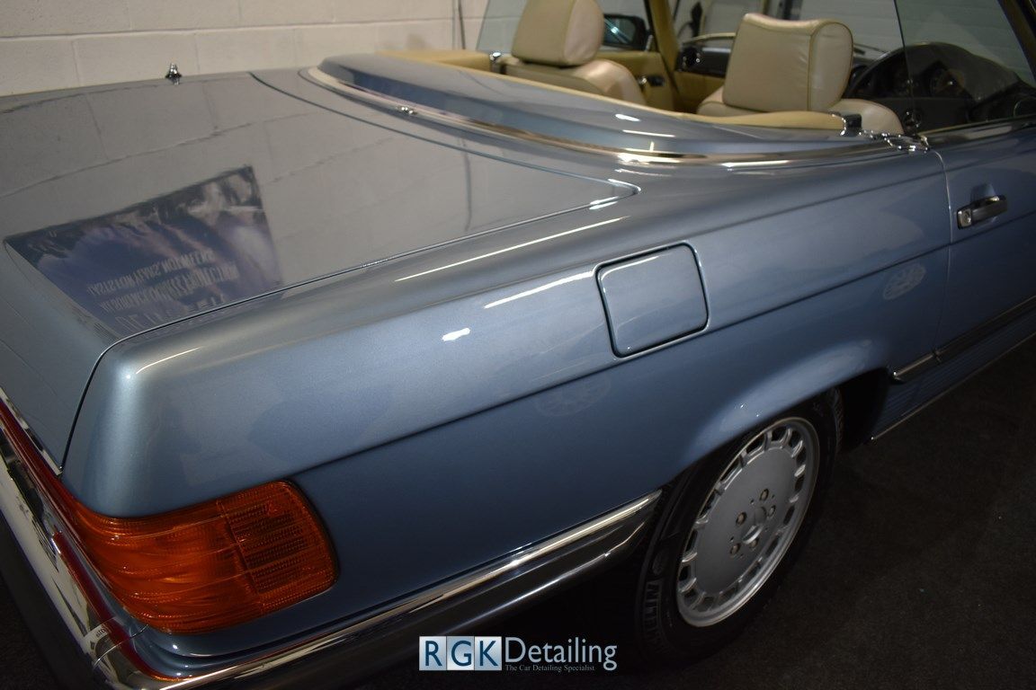 A blue car with the word rgk detailing on the bottom