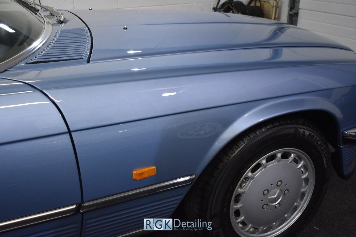 A blue car with the word rgk detailing on the side