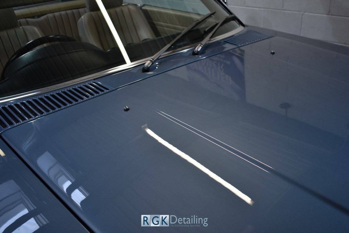 A close up of a car hood with the words rgk detailing on it