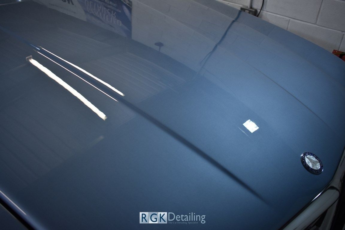 A close up of a car hood with rgk detailing written on it