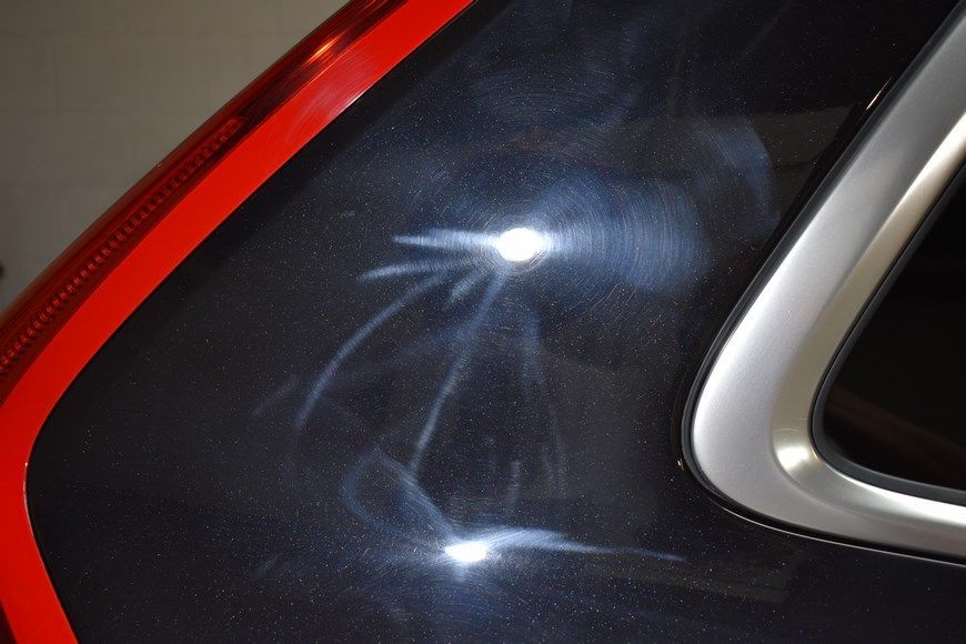 A close up of a black car with a red trim