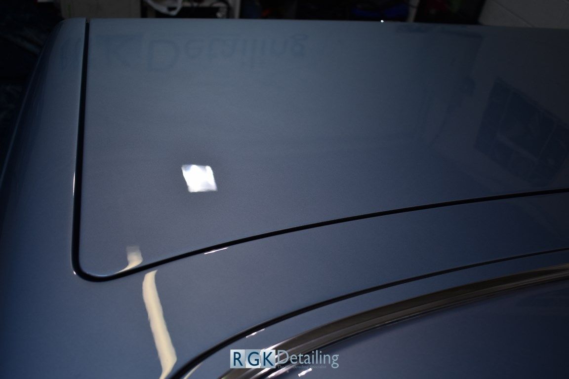 A close up of a car hood with rgk detailing written on it