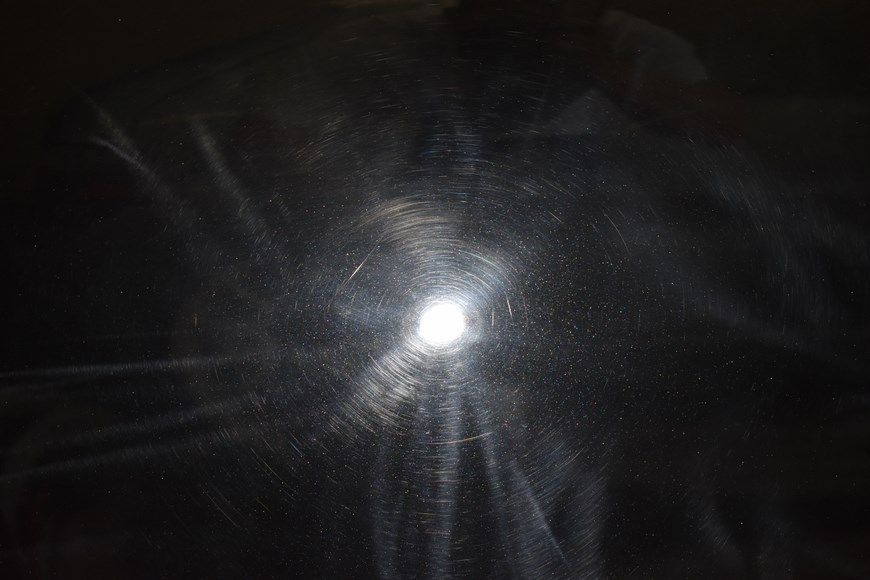A close up of a full moon in a dark room.