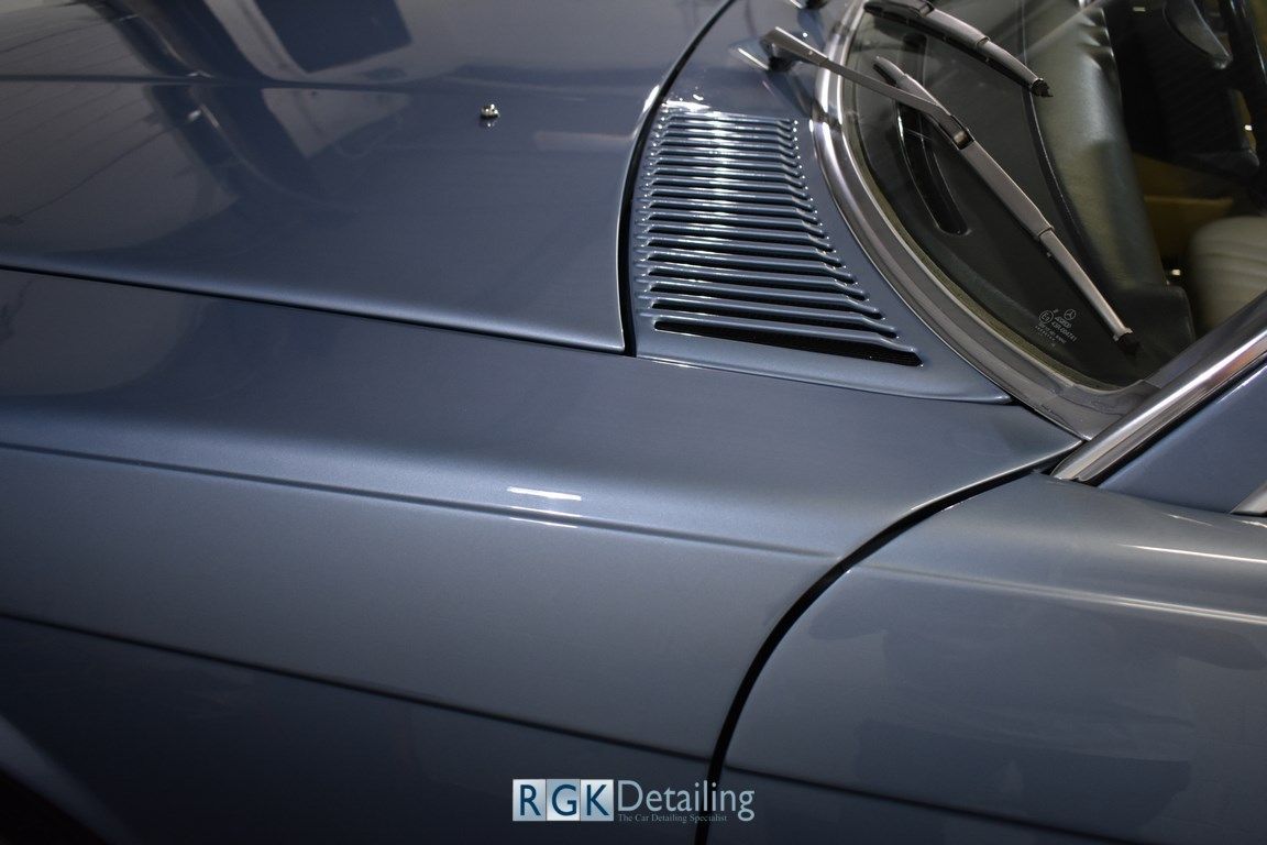 A close up of the hood of a car with rgk detailing written on it