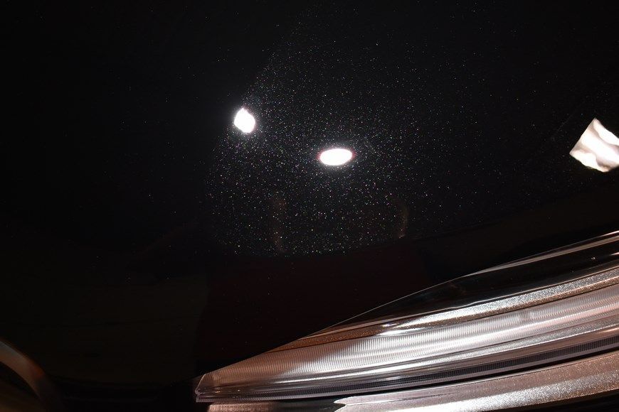 A close up of a car 's headlight with a black background