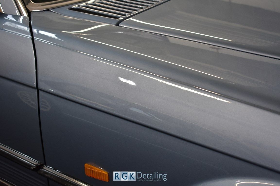 A close up of a car hood with rgk detailing written on it