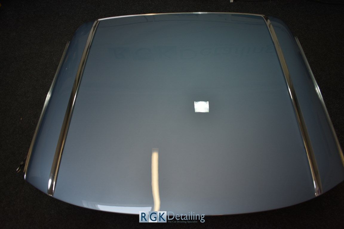 A close up of a car windshield that says rgk detailing