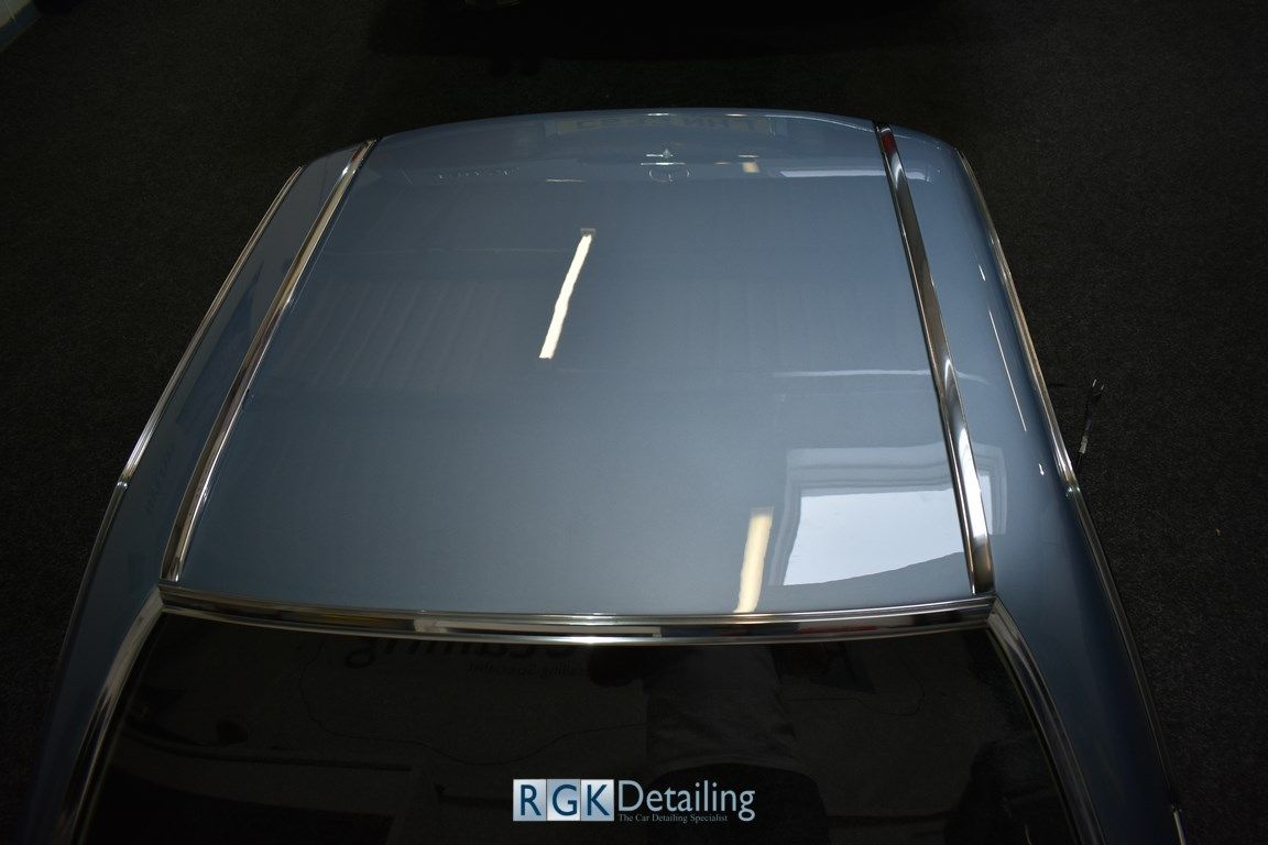 A close up of the roof of a car that says rgk detailing