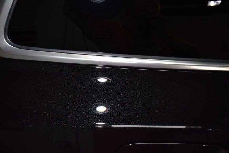 A close up of a black car with a silver trim