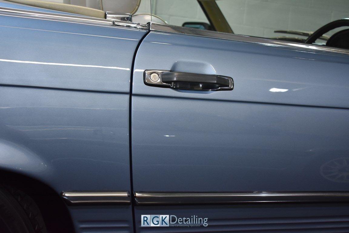 A close up of a car door with a sticker that says rgk detailing