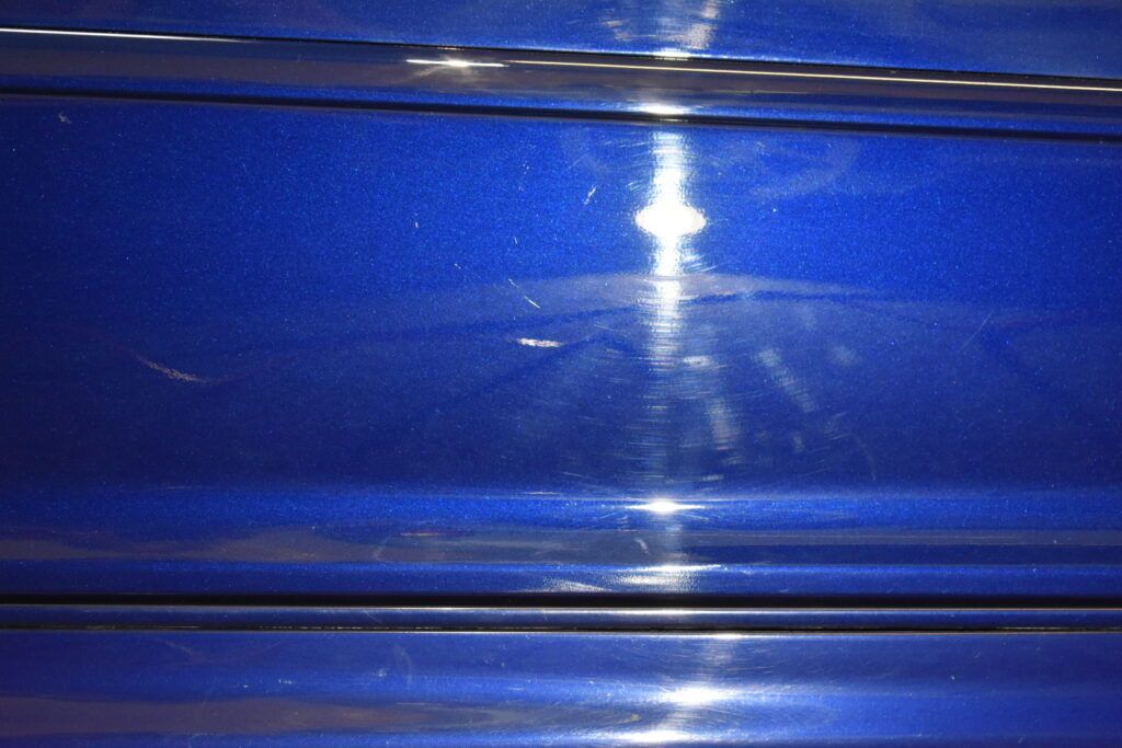 A close up of a blue plastic container with a light shining through it.