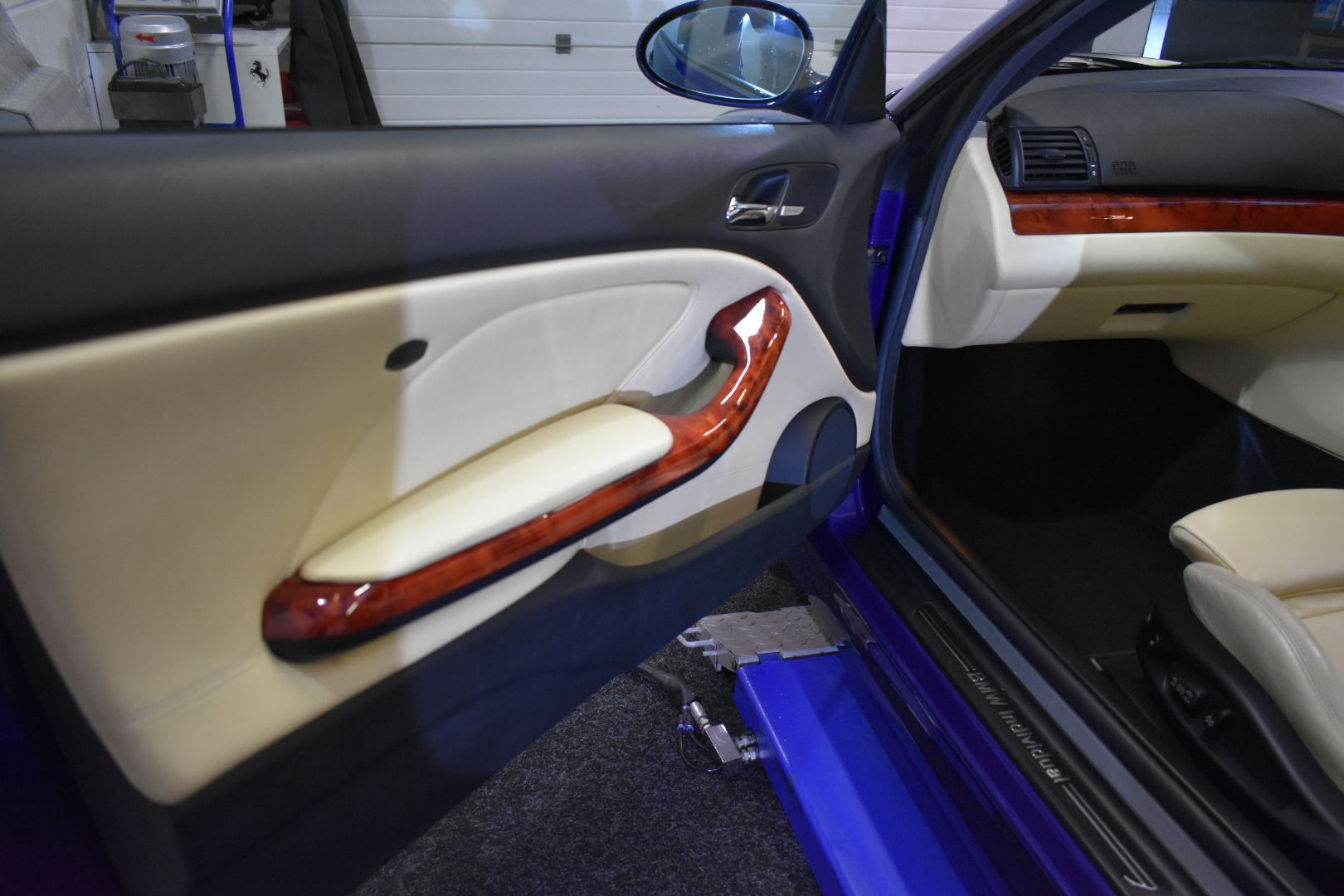 The inside of a blue car with the door open