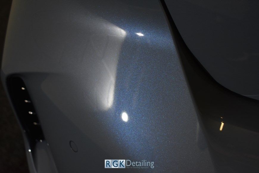 A close up of a car 's bumper with the words rgk detailing on the bottom