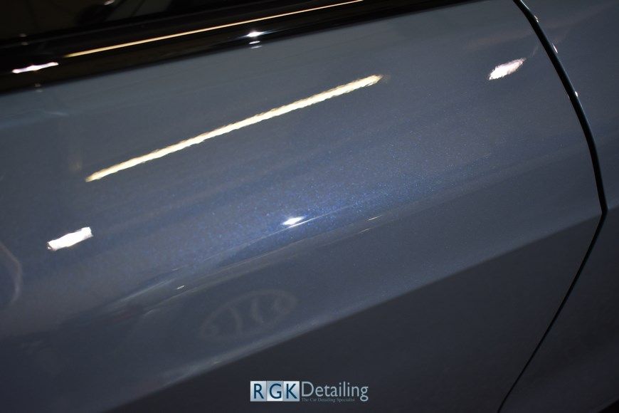 A close up of a car door with the words rgk detailing on it