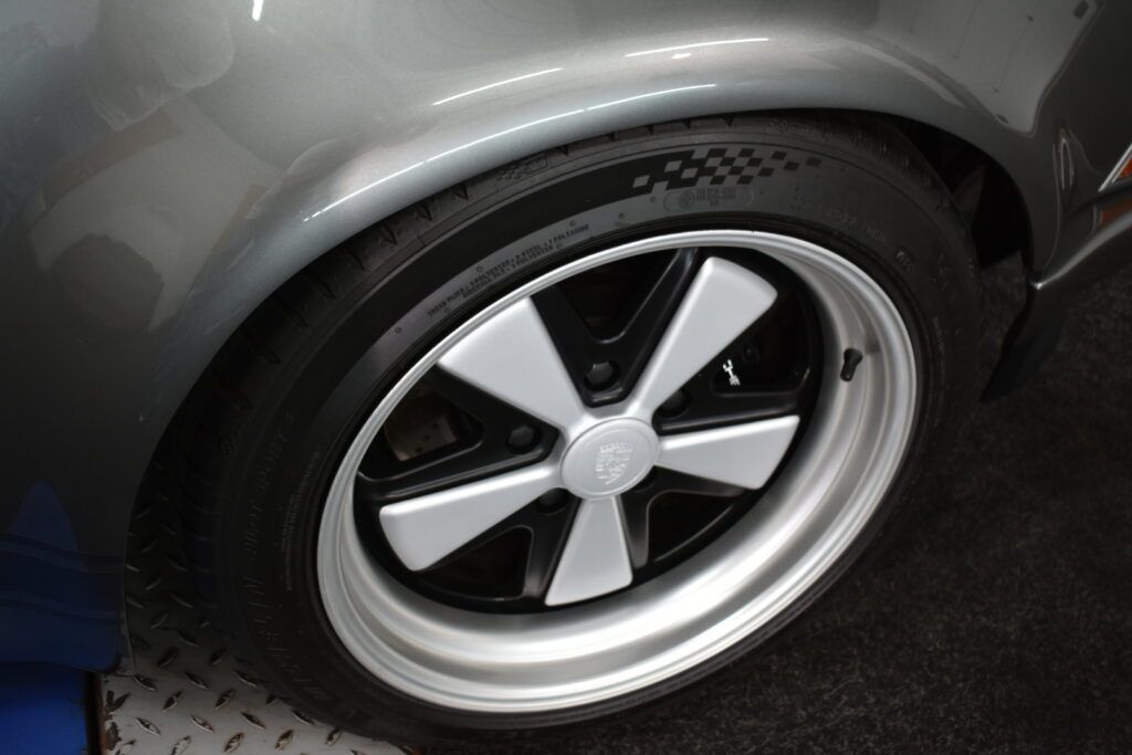 A close up of a car wheel with a white star on it.