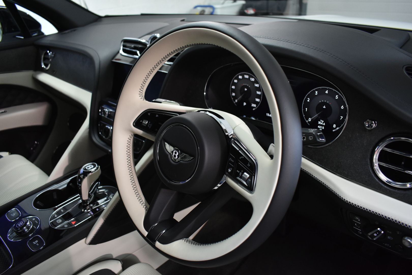 The steering wheel of a bentley is black and white