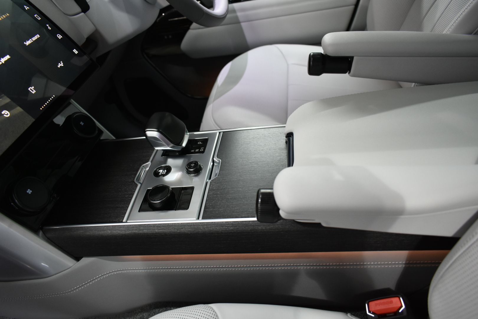 The interior of a car with a steering wheel and a dashboard.