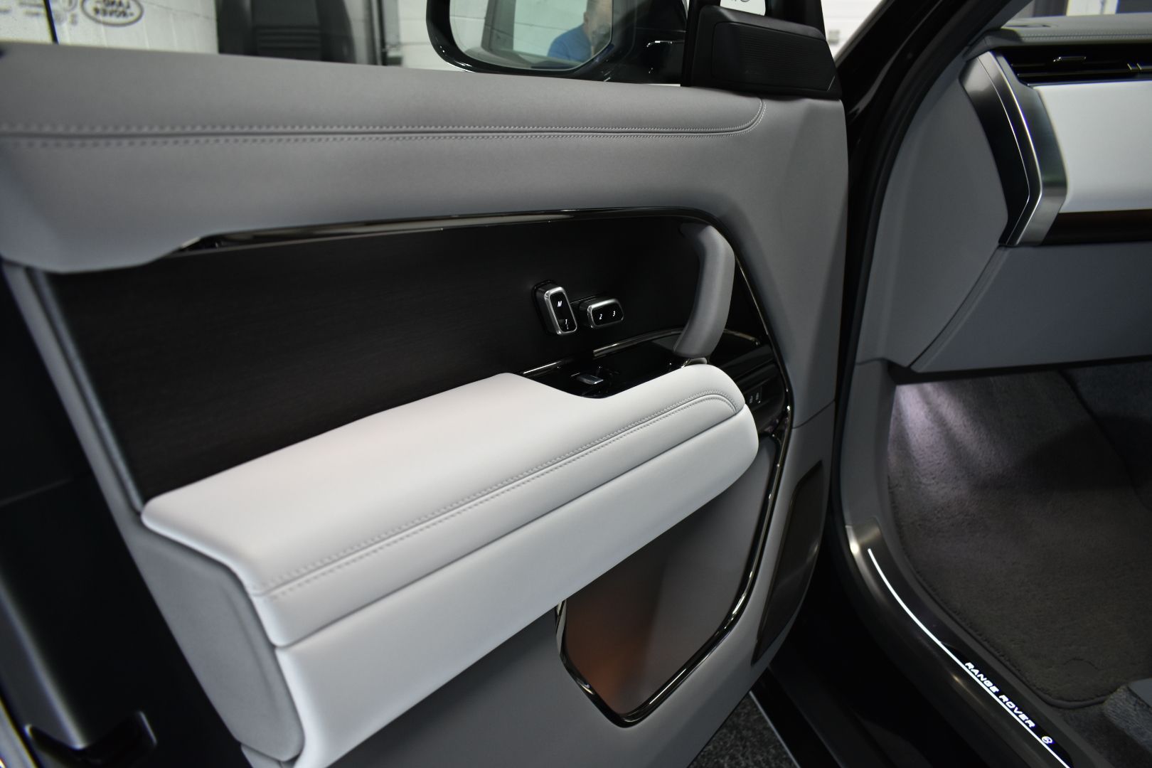 The inside of a black car with the door open