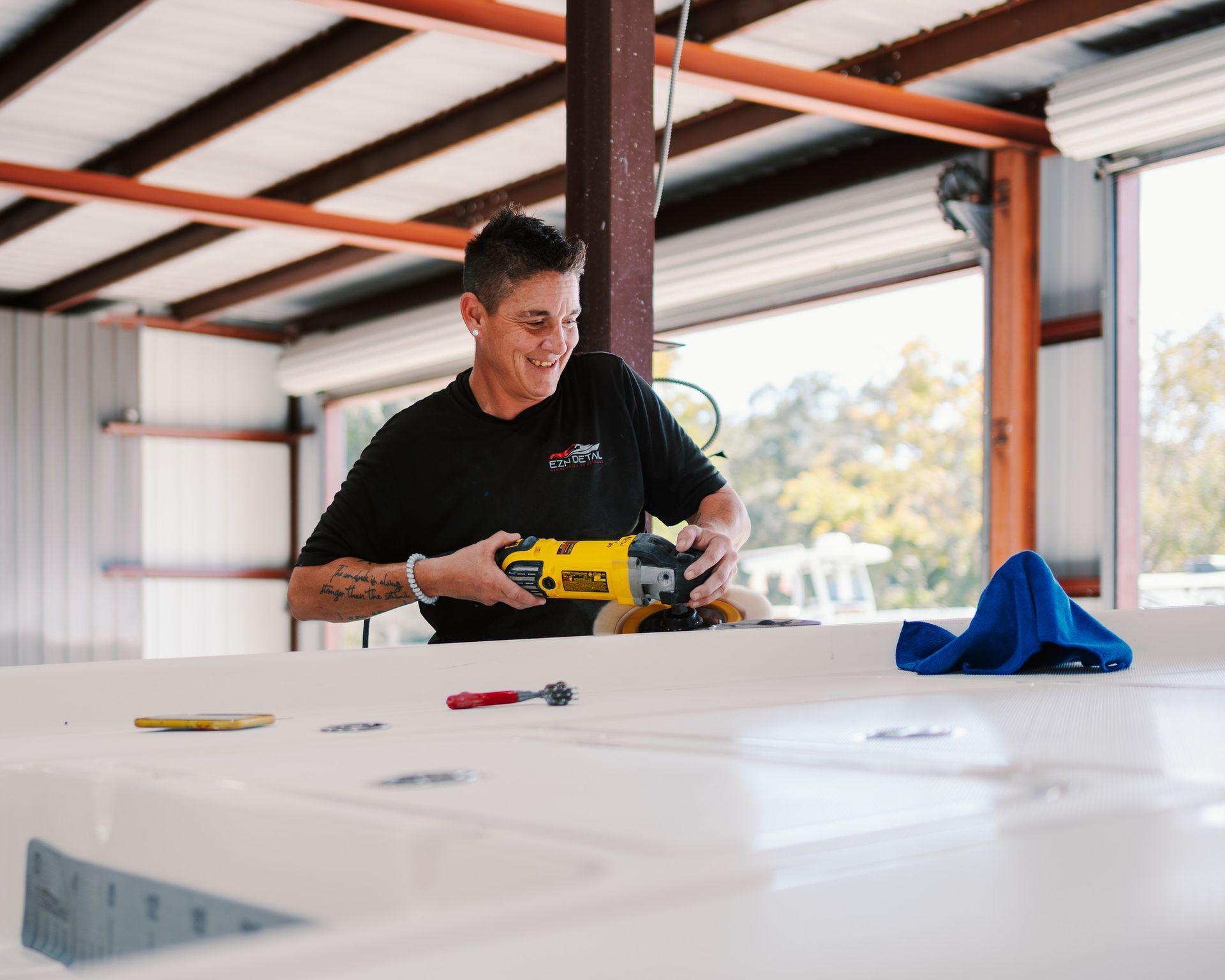 A woman is polishing a boat.