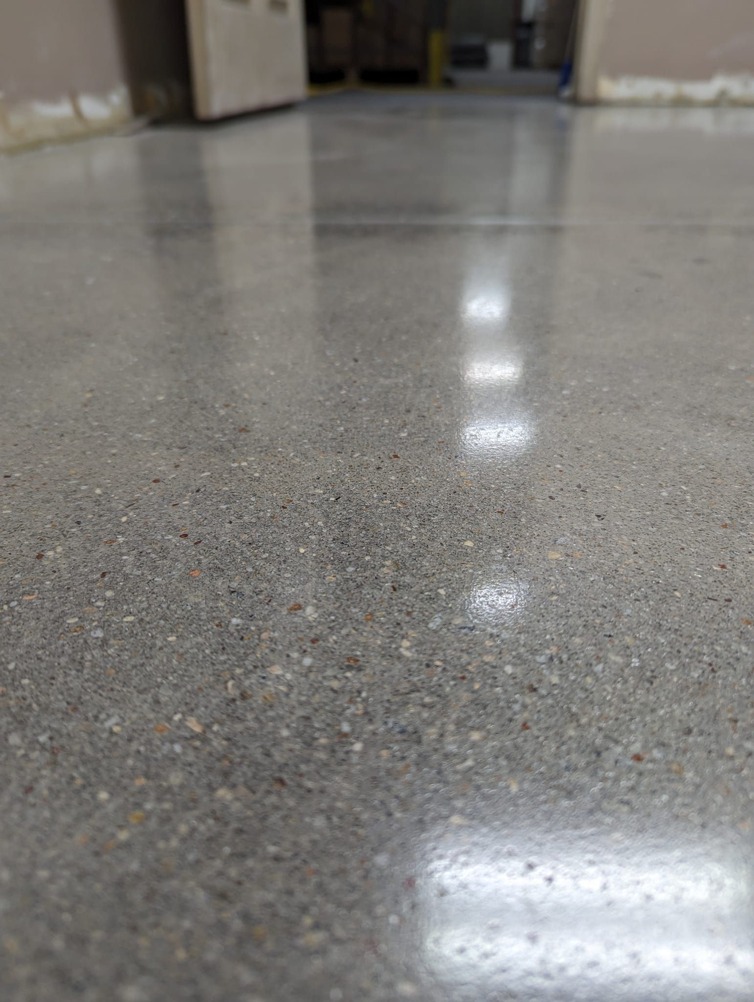 A close up of a shiny concrete floor in a room.