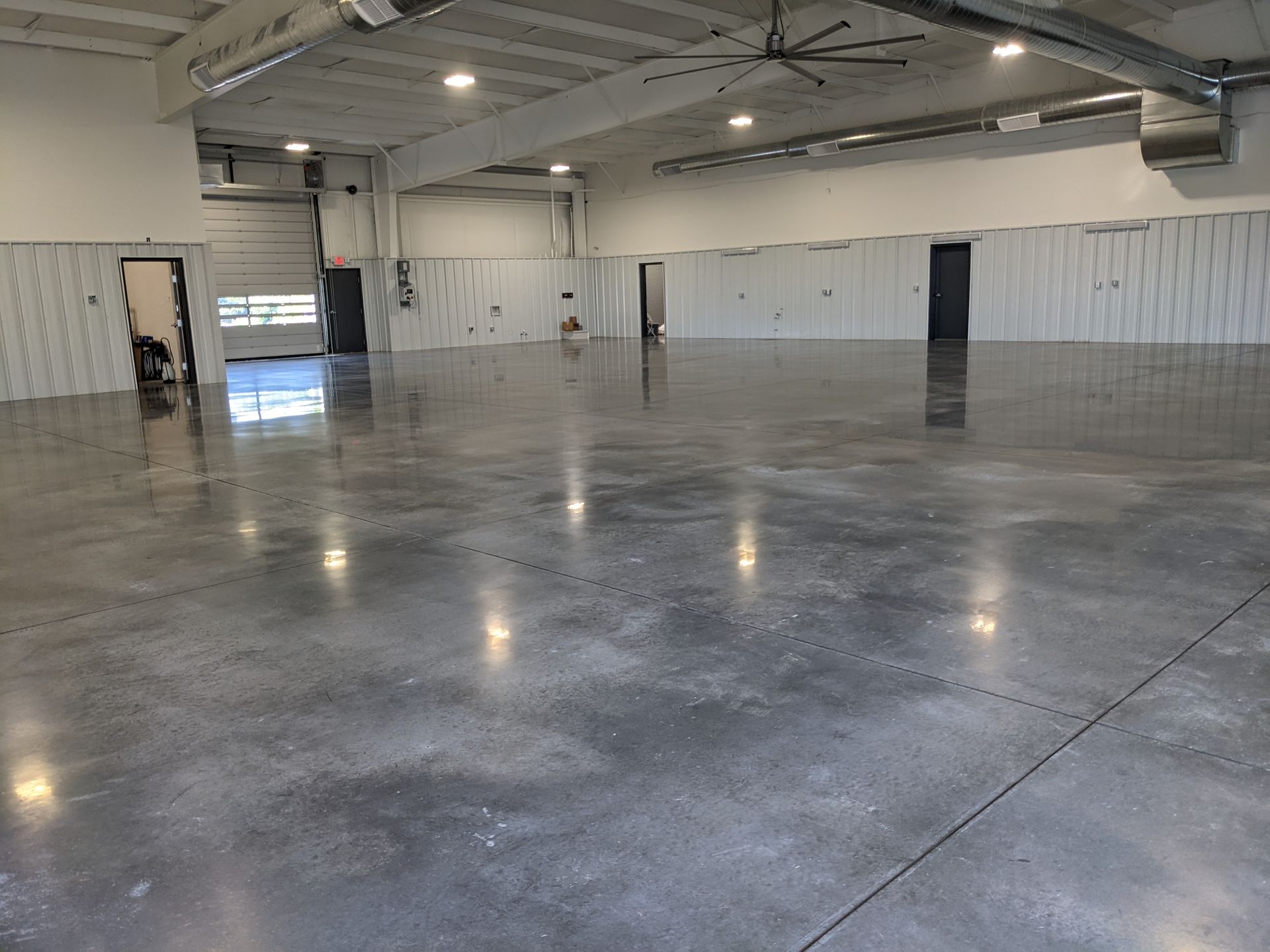 A large empty warehouse with a ceiling fan
