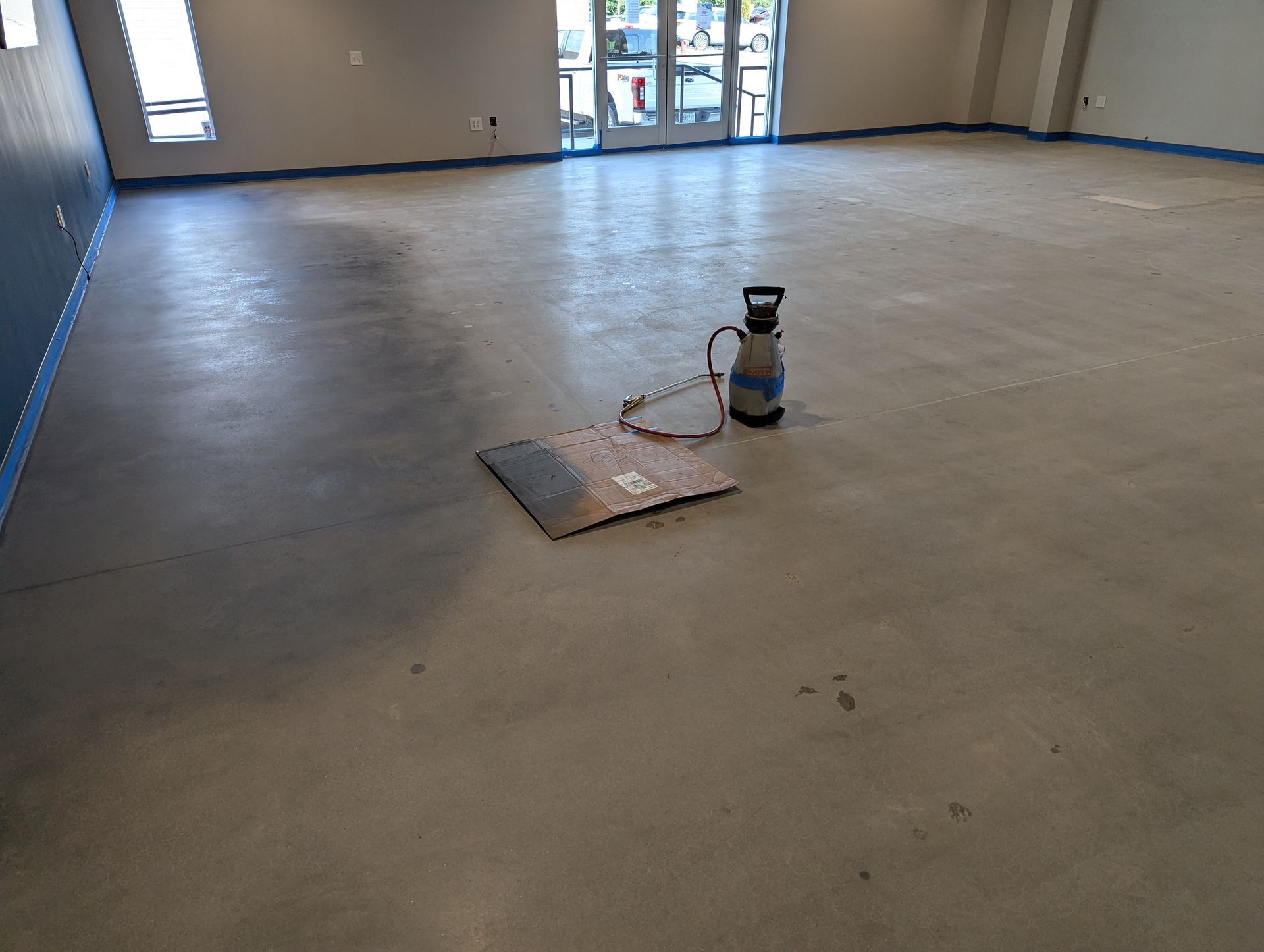 An empty room with a vacuum cleaner on the floor.