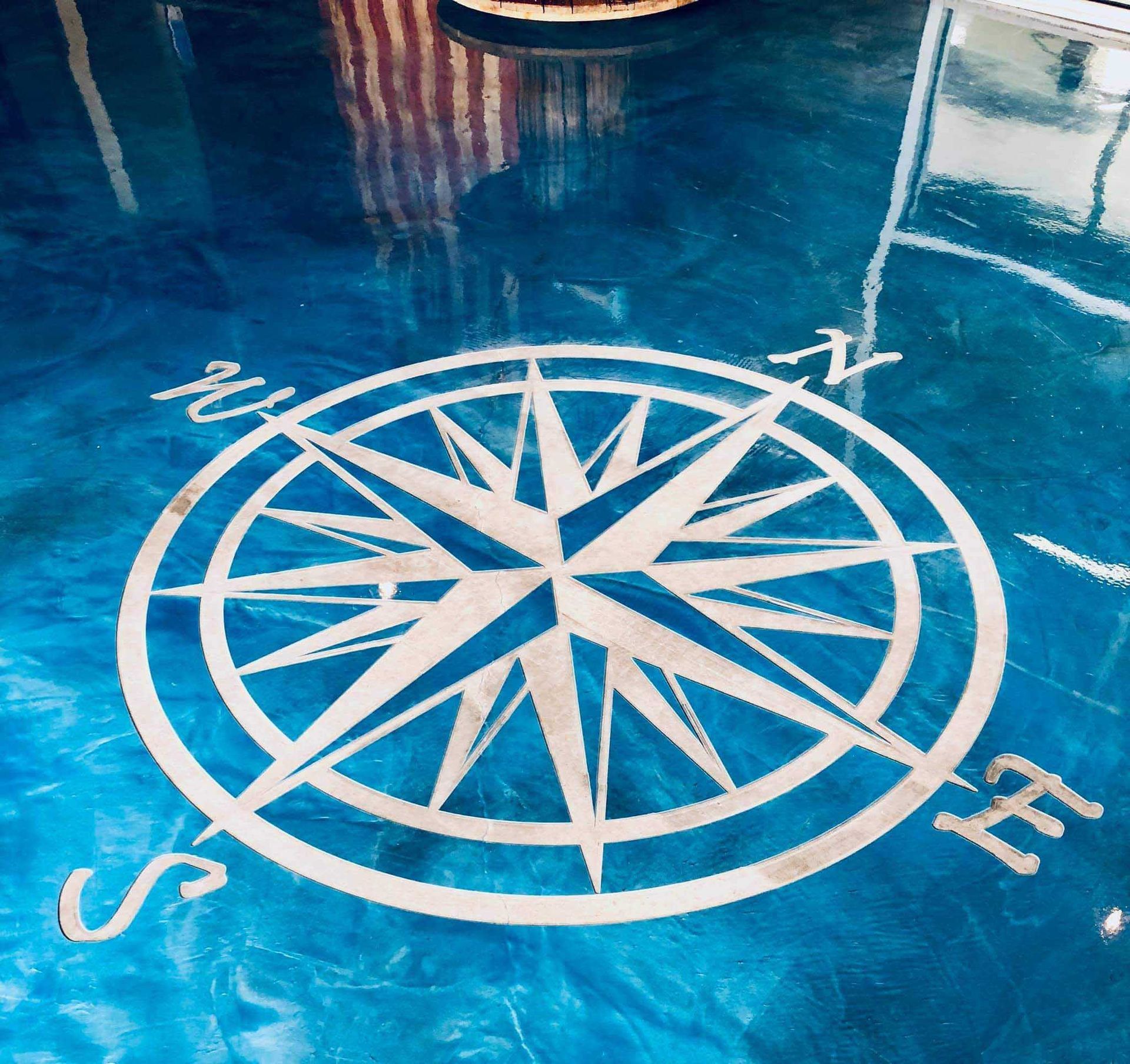 A blue floor with a compass engravedon it