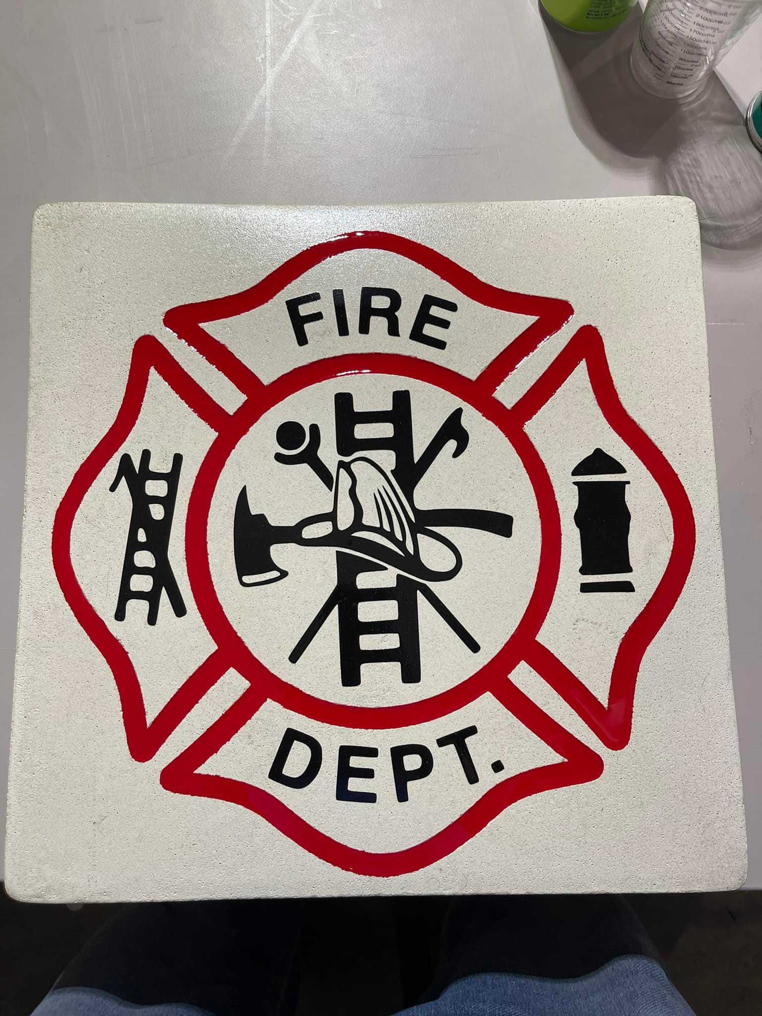 A sign that says fire dept on it engraved on concrete
