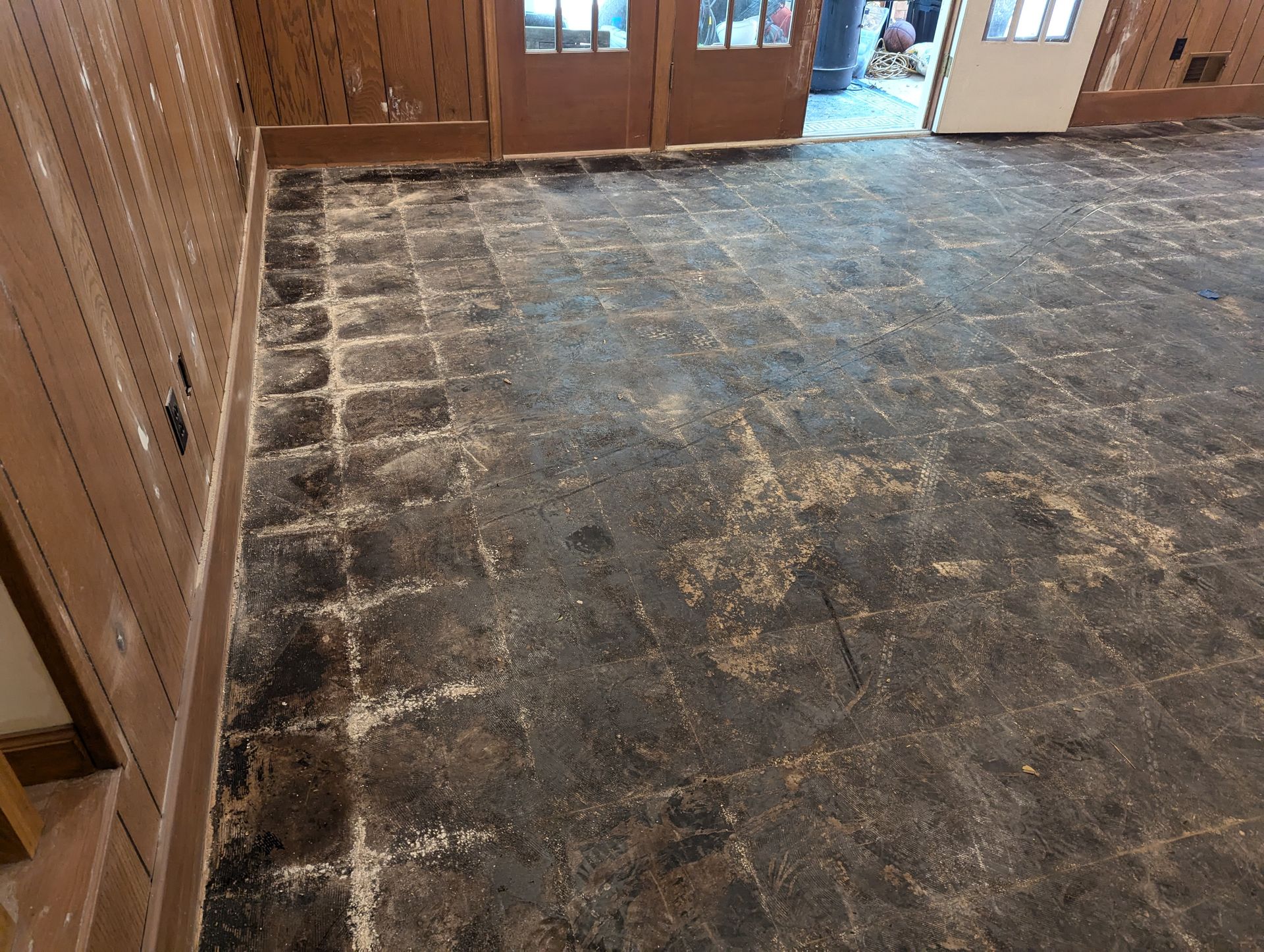 A room with a tiled floor and wooden walls.