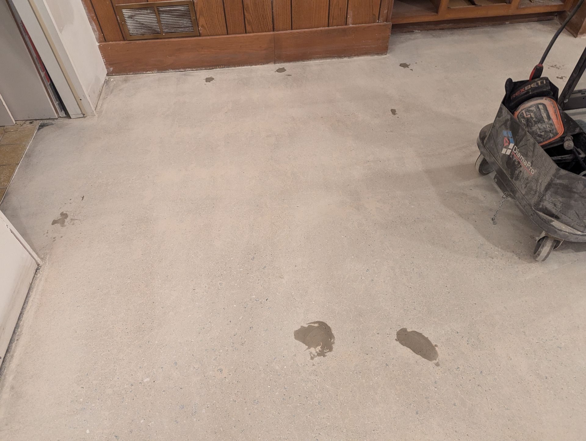 A vacuum cleaner is sitting on the floor of a room.