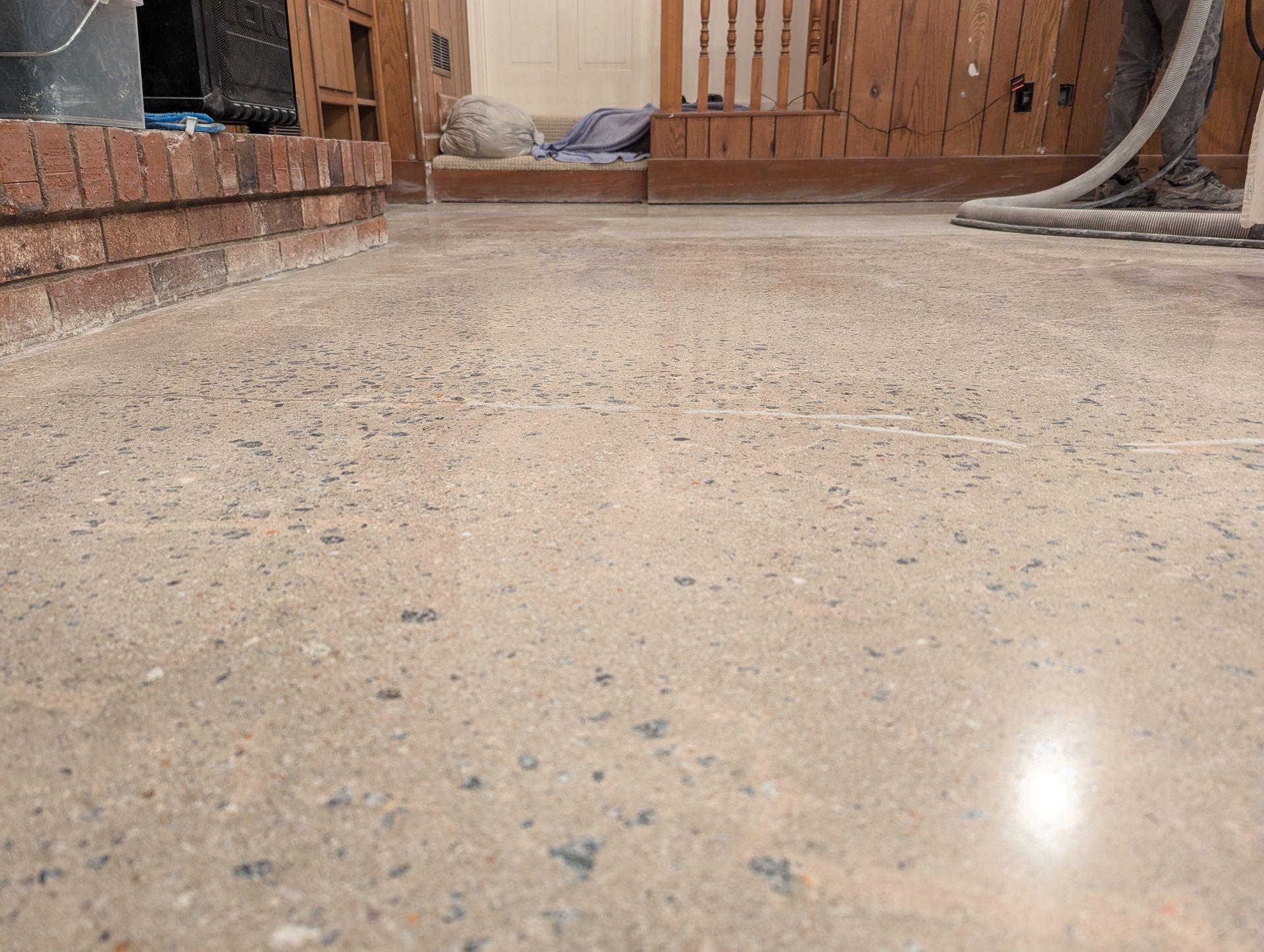 A close up of a concrete floor in a room with a vacuum cleaner.