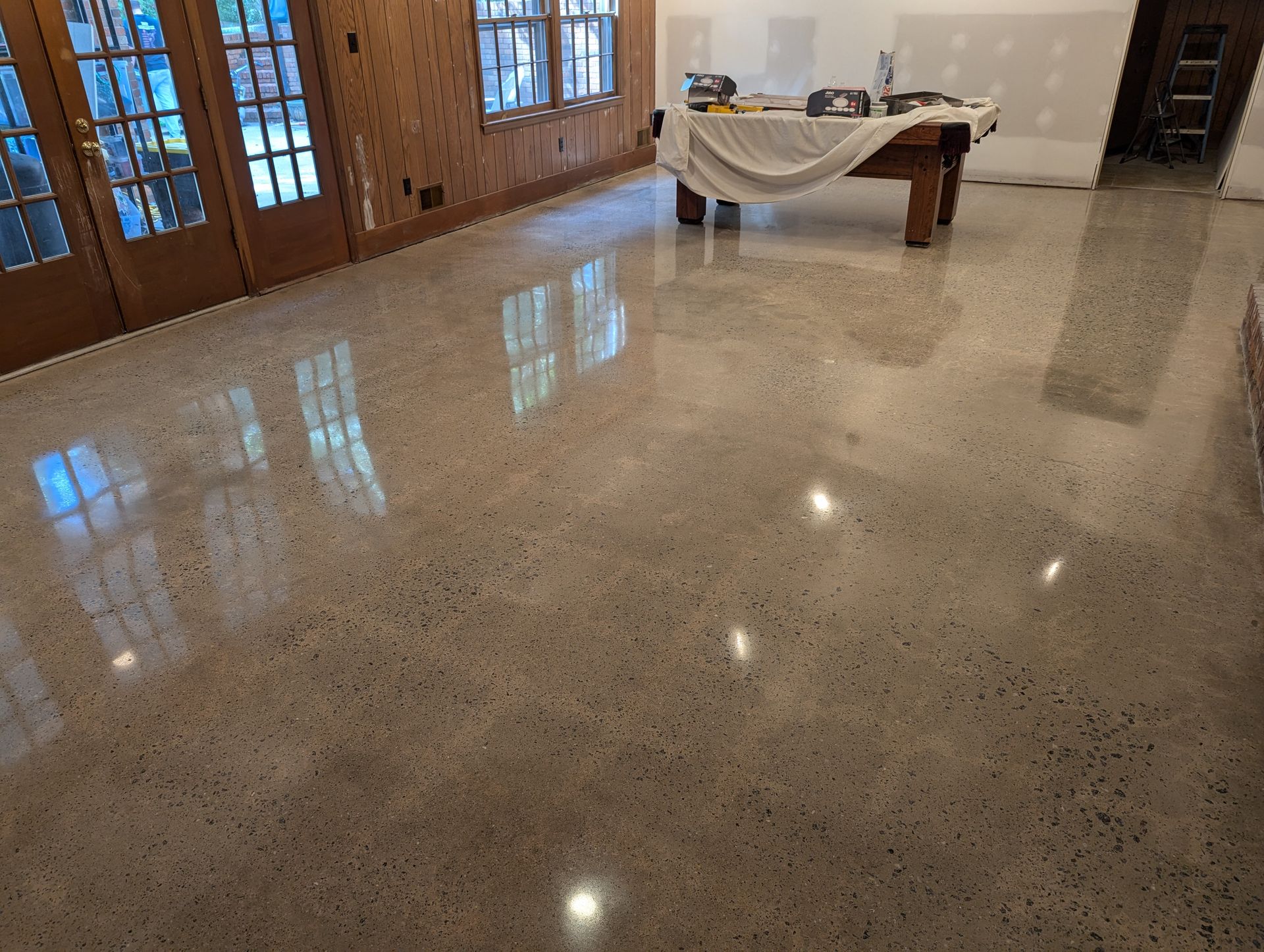 There is a pool table in the middle of the room.