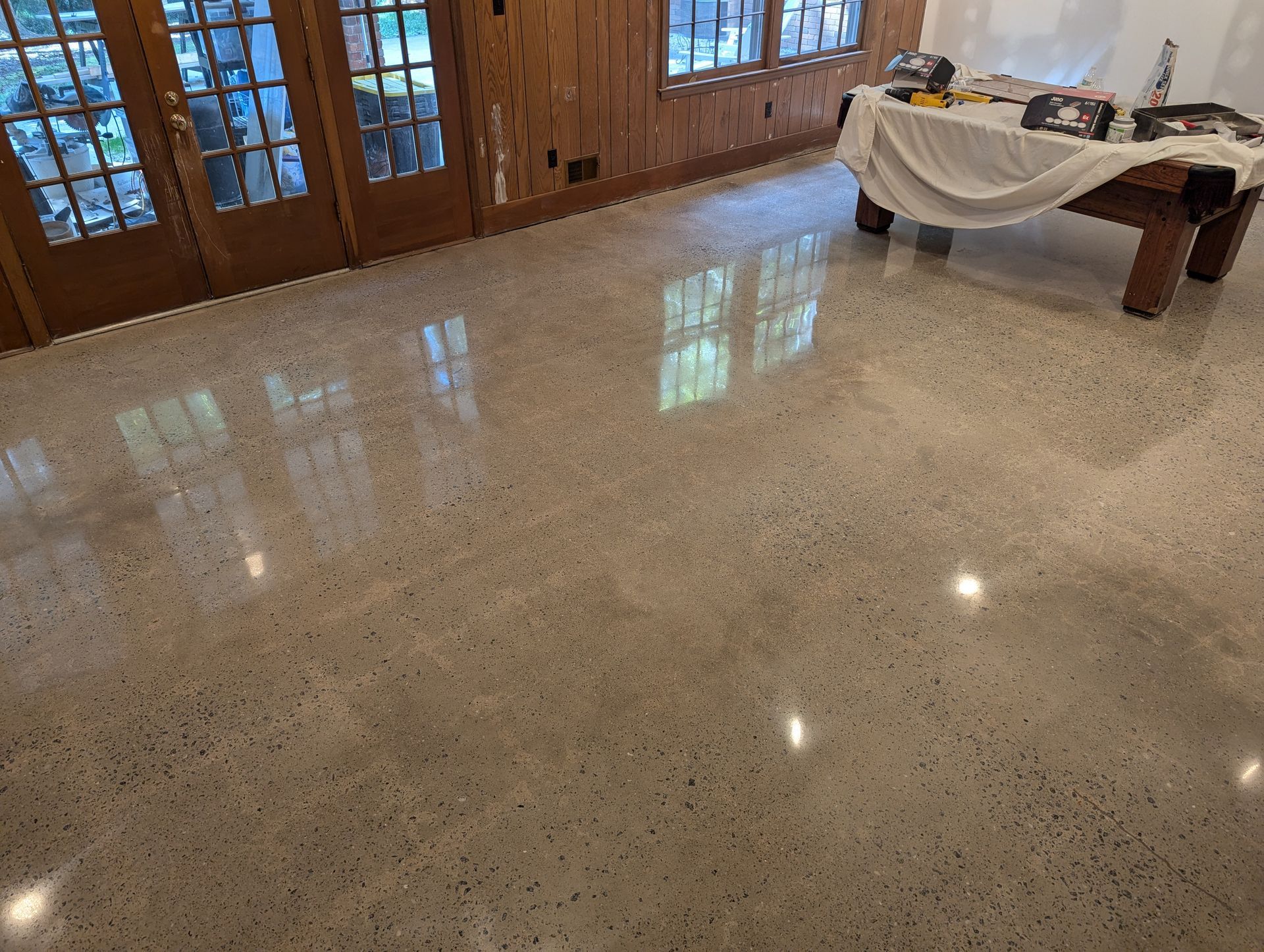 There is a pool table in the middle of the room.